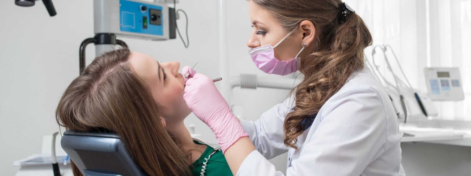 Lady dentist checking on her patient
